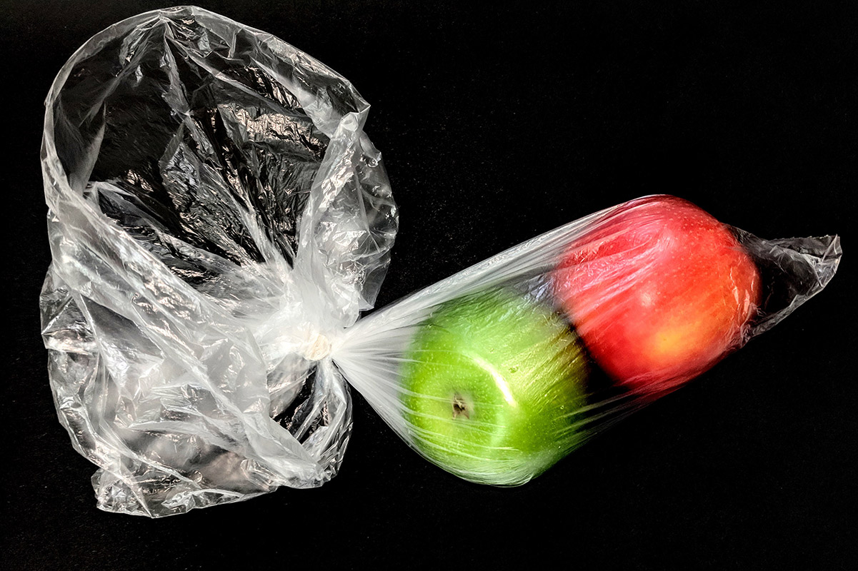 two apples in a single use plastic bag